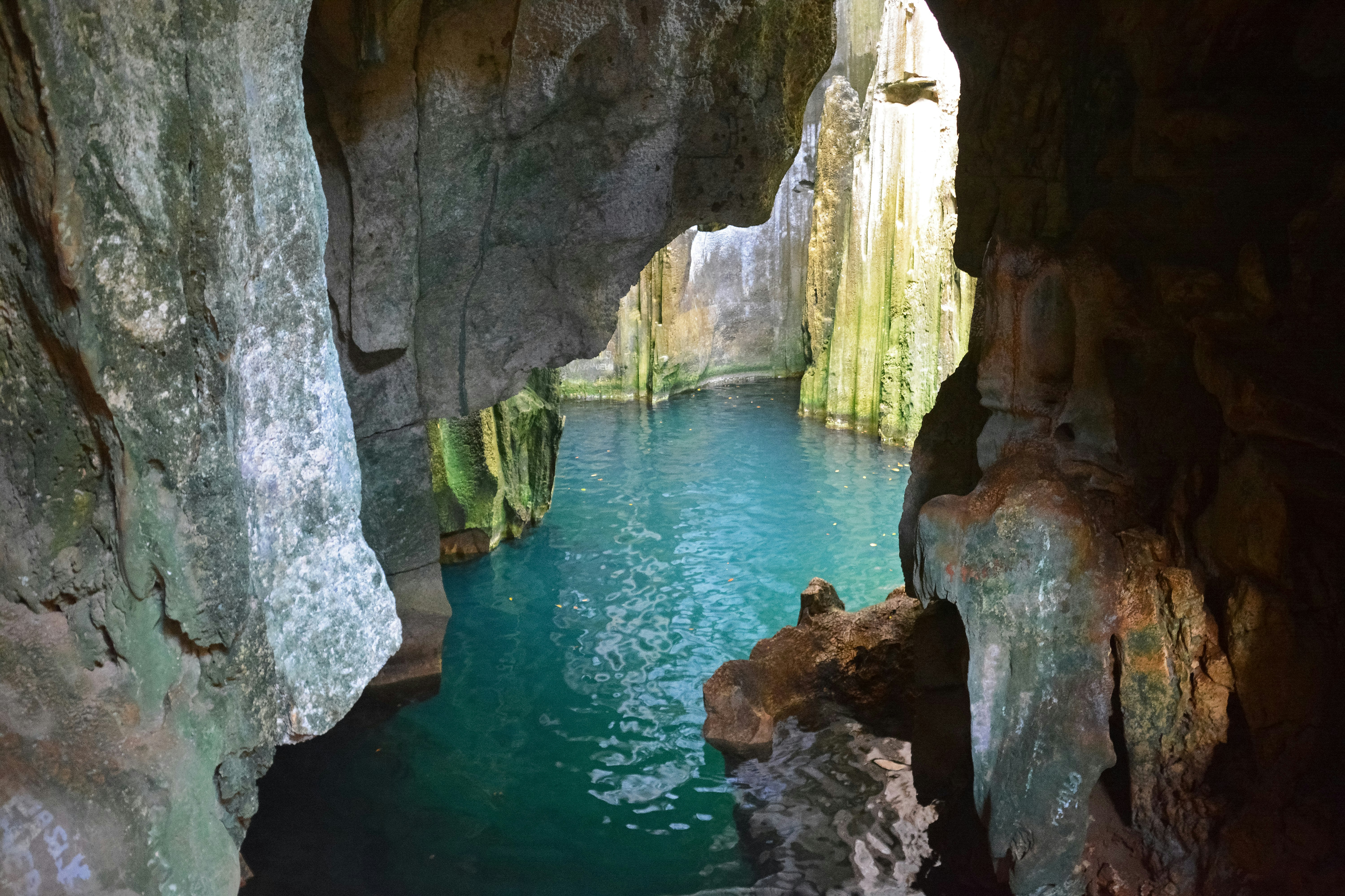 brown rock formation on body of water during daytime